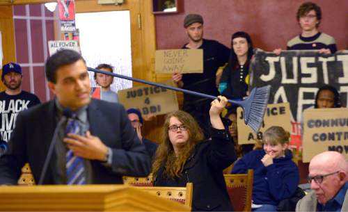 Leah Hogsten  |  The Salt Lake Tribune
"The only way we can consider something like this as a threat, is as a joke," said Colin Williams who took a broom to the podium with him. Ian Decker (right) holds the broom after council members told him he could not hold the broom while addressing the city council. About 30 citizen and members of Utah Against Police Brutality stood with signs at the Salt Lake City Council meeting open session, Tuesday, March 15, 2016, to speak their minds on the need for an independent, democratically-elected, Community-Controlled Police Review Board in the wake of the shooting of Somali refugee Abdullahi Mohamed by Salt Lake City Police last month. Members of the community called for justice for Abdi Mohamed, community control and the release of the SLCPD body-cam footage.