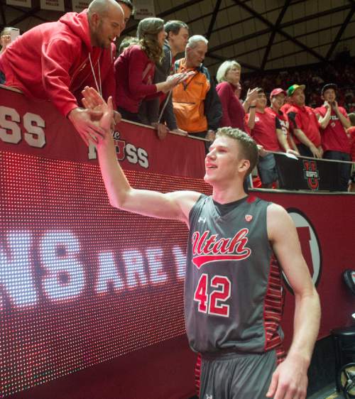 Rick Egan  |  The Salt Lake Tribune

Utah Utes forward Jakob Poeltl (42) high-fives fans after the Utes 57-55 win over Colorado, in Pac-12 basketball action at the Huntsman Center Saturday, March 5, 2016.