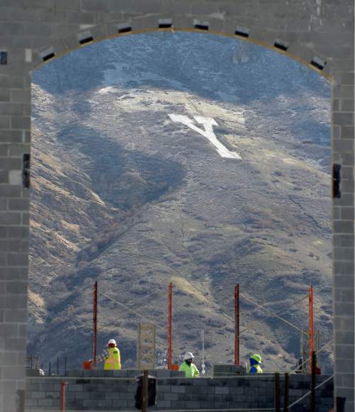 Al Hartmann  |  The Salt Lake Tribune
Sun lights up "Y" on the rugged mountain face east of the BYU campus as construction workers build a new student apartment building Wednesday March 16.