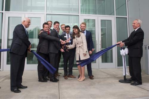 Rick Egan  |  The Salt Lake Tribune

 Douglas D. Anderson, Dean, Jon M. Huntsman School of Business and Stan L. Albrecht, President, Utah State University hold the ribbon as business students cut the ribbon, as they celebrate the new $50 Million building in the Jon M. Huntsman School of Business, Wednesday, March 16, 2016.