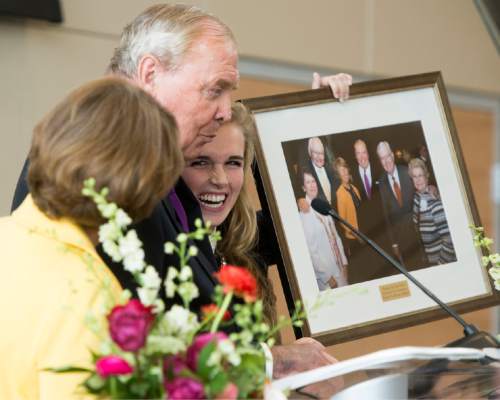 Rick Egan  |  The Salt Lake Tribune

Grand daughter Ruby, holds up a photo of the Huntsman's with L. Tom Perry,  as they celebrate the new $50 Million building in the Jon M. Huntsman School of Business, Wednesday, March 16, 2016.