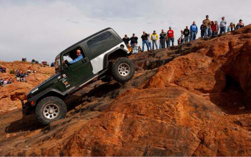 Trent Nelson  |  The Salt Lake Tribune 
Steve Moore of Springfield, MO pilots his Jeep down Potato Salad Hill. Thousands of Jeeps descended on the trails surrounding Moab for the annual Easter Jeep Safari, Saturday April 11, 2009.