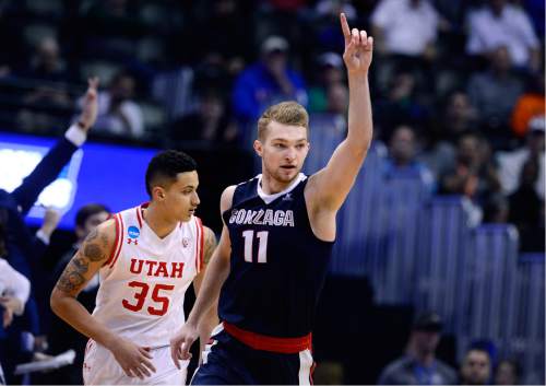 Scott Sommerdorf   |  The Salt Lake Tribune  
Gonzaga F Domantas Sabonis (11) reacts to making another shot during second half play. Sabonis scored 19 pints and seemed to win the battle against Utah F Jakob Poeltl (42). Gonzaga beat Utah 82-59 in Denver, Saturday, March 19, 2016.
