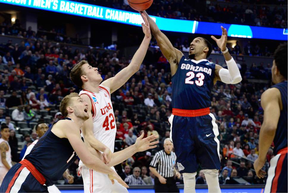 Scott Sommerdorf   |  The Salt Lake Tribune  
Utah F Jakob Poeltl (42) and Gonzaga G Eric McClellan (23) battle over control of a loose ball as Gonzaga F Domantas Sabonis (11) is at left during second half play. Gonzaga beat Utah 82-59 in Denver, Saturday, March 19, 2016.