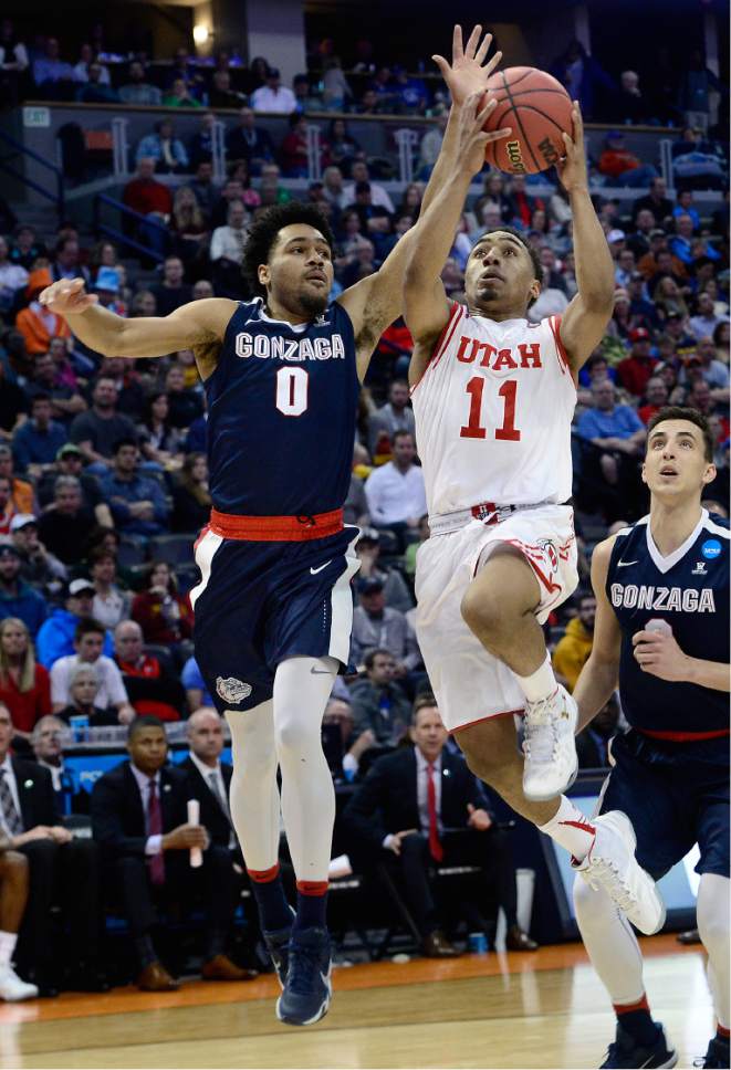 Scott Sommerdorf   |  The Salt Lake Tribune  
Utah G Brandon Taylor (11) drives against Gonzaga G Silas Melson (0) during second half play. Gonzaga beat Utah 82-59 in Denver, Saturday, March 19, 2016.