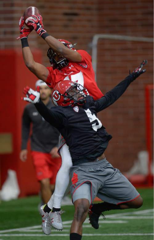 Francisco Kjolseth | The Salt Lake Tribune
Wide receiver Demari Simpkins holds on to the ball by his finger tips as Tavaris Williams tries to disrupt the interception as the University of Utah football team kicks off opening day of spring practice on Tuesday, March 22, 2016.