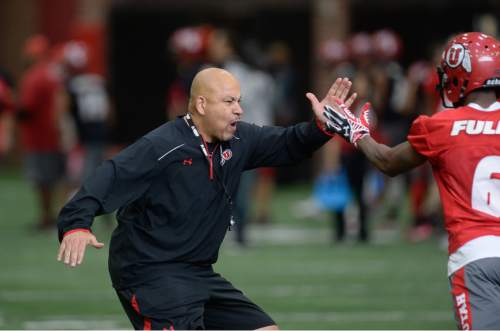Francisco Kjolseth | The Salt Lake Tribune
University of Utah wide receiver coach Guy Holliday encourages his the team running drills as the team kicks off opening day of spring practice on Tuesday, March 22, 2016.