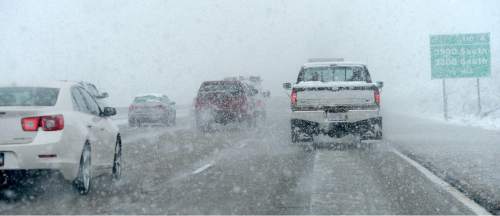 Al Hartmann  |  The Salt Lake Tribune
Wet, heavy snow made driving slow and visibility difficult for motorists along northbound I-215 near the mountains Tuesday morning March 22.