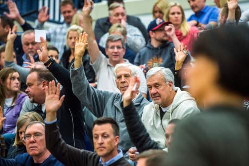 Chris Detrick  |  The Salt Lake Tribune
Voters in precinct 13 raise their hands to indicate they have not yet received a presidential ballet during the Republican caucus at Corner Canyon High School Tuesday March 22, 2016.