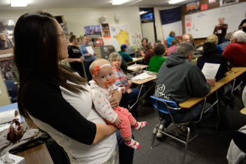 Francisco Kjolseth | The Salt Lake Tribune
Lily Blauer, 4-months, keep calm with the help of a binky as her mother Marissa attends a GOP caucus meeting at Cottonwood High School on Tuesday night, March 22, 2016.