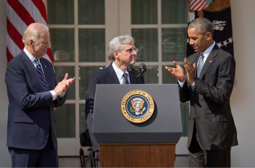 Federal appeals court judge Merrick Garland, stands with President Barack Obama and Vice President Joe Biden as he is introduced as Obama's nominee for the Supreme Court during an announcement in the Rose Garden of the White House, in Washington, Wednesday, March 16, 2016.  Garland, 63, is the chief judge for the United States Court of Appeals for the District of Columbia Circuit, a court whose influence over federal policy and national security matters has made it a proving ground for potential Supreme Court justices.  (AP Photo/Pablo Martinez Monsivais)