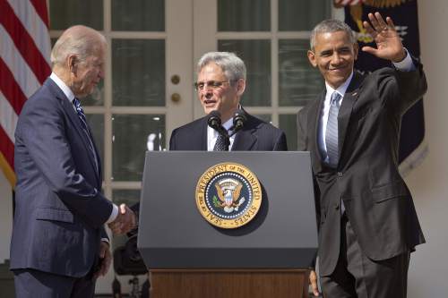Federal appeals court judge Merrick Garland, center, stands with President Barack Obama and Vice President Joe Biden after being introduced as Obama's nominee for the Supreme Court during an announcement in the Rose Garden of the White House, in Washington, Wednesday, March 16, 2016.  Garland, 63, is the chief judge for the United States Court of Appeals for the District of Columbia Circuit, a court whose influence over federal policy and national security matters has made it a proving ground for potential Supreme Court justices.  (AP Photo/Pablo Martinez Monsivais)
