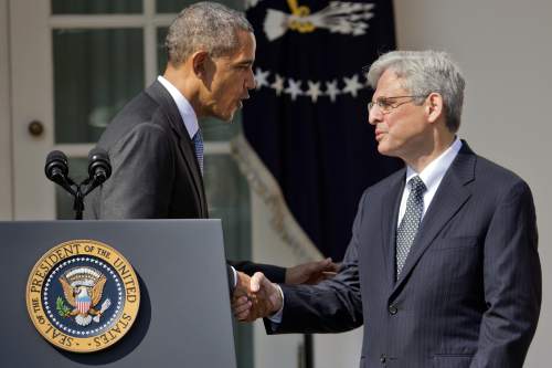Federal appeals court judge Merrick Garland, right, shakes hands with President Barack Obama as he is introduced as Obama's nominee for the Supreme Court during an announcement in the Rose Garden of the White House, in Washington, Wednesday, March 16, 2016.  Garland, 63, is the chief judge for the United States Court of Appeals for the District of Columbia Circuit, a court whose influence over federal policy and national security matters has made it a proving ground for potential Supreme Court justices.  (AP Photo/Pablo Martinez Monsivais)