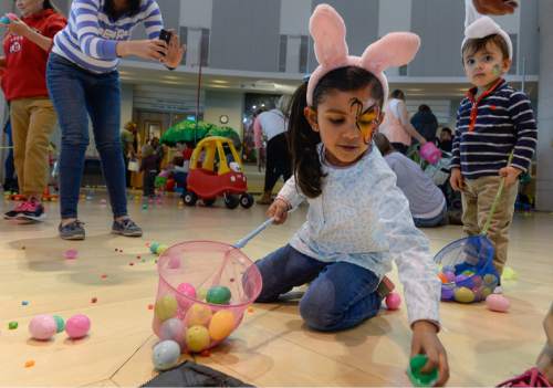 Francisco Kjolseth | The Salt Lake Tribune
Lucia Lobo, 4, and her brother Luciano, 1, scramble to get as many eggs as they can. Shriners Hospitals hosted an Easter Egg Hunt adapted for patients with physical challenges. Around 100 patients and their families attended Wednesdayís annual Easter Egg Hunt, which gave children with physical challenges who may be in wheelchairs or rely on the assistance of a walker, the space, time and support they needed to enjoy the Spring time tradition.