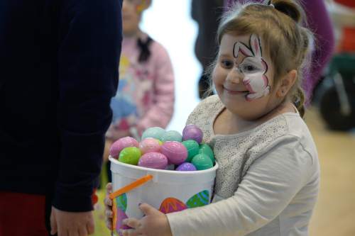 Francisco Kjolseth | The Salt Lake Tribune
Gracie Davis, 9, keeps a firm hold on her collection of eggs as Shriners Hospitals hosts an Easter Egg Hunt adapted for patients with physical challenges. Around 100 patients and their families attended Wednesday's annual Easter Egg Hunt, which gave children with physical challenges who may be in wheelchairs or rely on the assistance of a walker, the space, time and support they needed to enjoy the Spring time tradition.