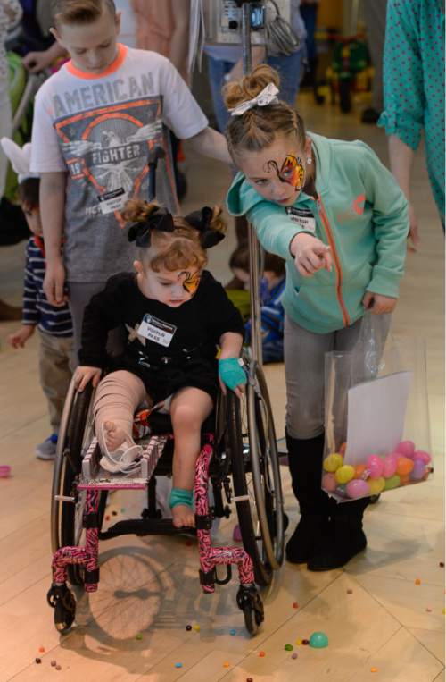 Francisco Kjolseth | The Salt Lake Tribune
Hadley Larsen, 3, center, is joined by her siblings Parker, 11, and Kinzley, 8, as they hunt down eggs together. Shriners Hospitals hosted an Easter Egg Hunt adapted for patients with physical challenges. Around 100 patients and their families attended Wednesday's annual Easter Egg Hunt, which gave children with physical challenges who may be in wheelchairs or rely on the assistance of a walker, the space, time and support they needed to enjoy the Spring time tradition.