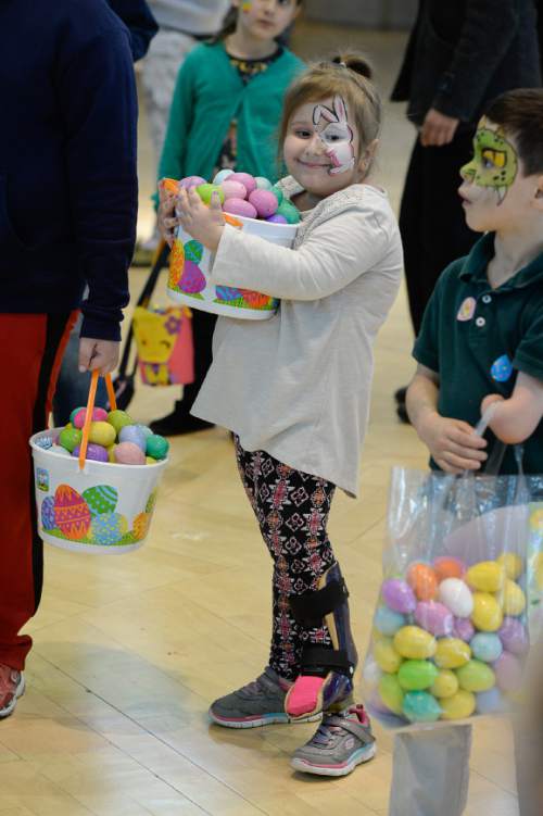 Francisco Kjolseth | The Salt Lake Tribune
Gracie Davis, 9, keeps a firm hold on her collection of eggs as Shriners Hospitals hosts an Easter Egg Hunt adapted for patients with physical challenges. Around 100 patients and their families attended Wednesday's annual Easter Egg Hunt, which gave children with physical challenges who may be in wheelchairs or rely on the assistance of a walker, the space, time and support they needed to enjoy the Spring time tradition.