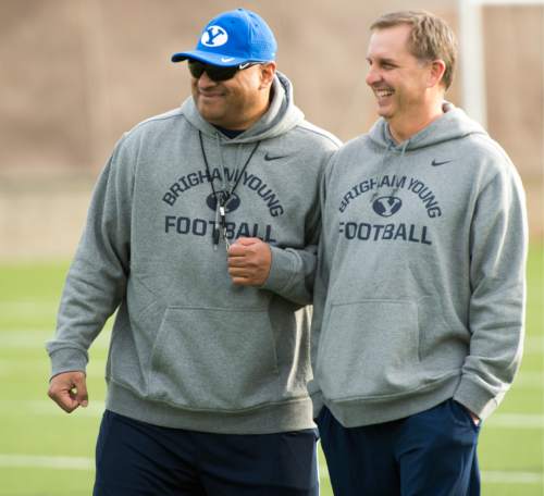 Rick Egan  |  The Salt Lake Tribune

BYU head coach Kalani Sitake  shares a laugh with quarterback coach Ty Detmer on the second day of spring practice, in Provo, Thursday, March 3, 2016.