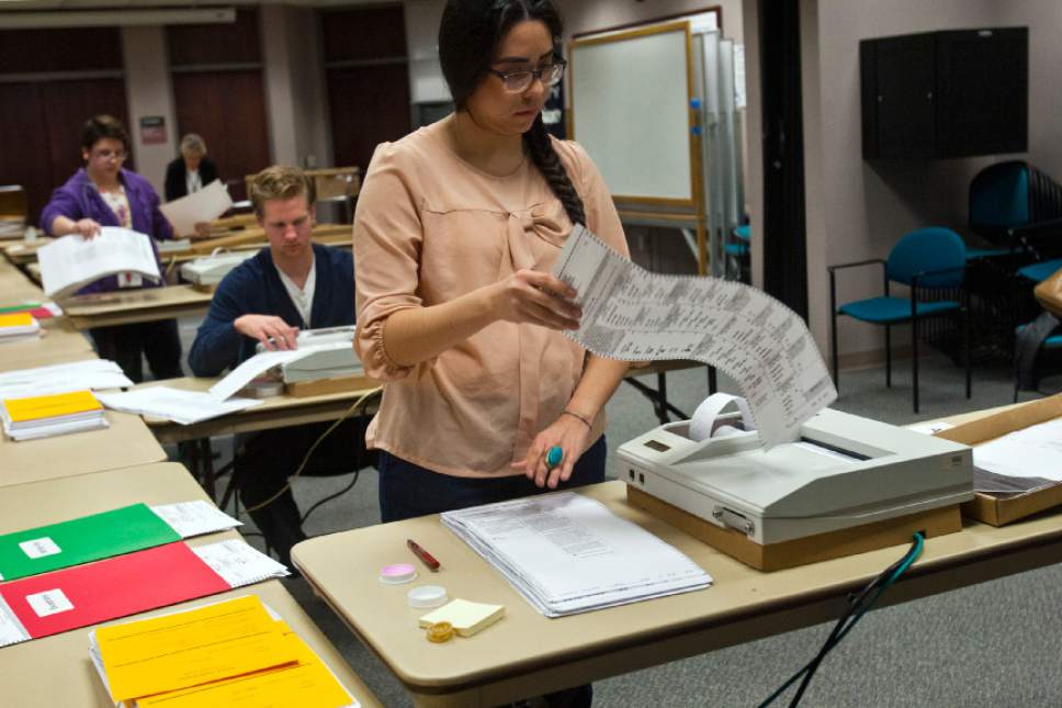 Chris Detrick  |  Tribune file photo
Gracie Velasquez scans ballots at the Salt Lake County clerk's office in a past election. Vote-by-mail is expected to handle most balloting in this year's primary and general election.