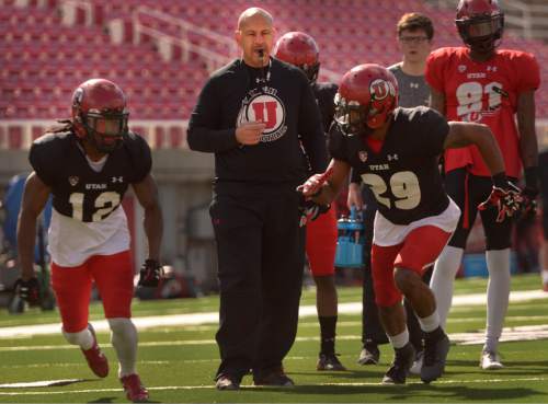 Leah Hogsten  |  The Salt Lake Tribune
Guy Holliday, University of Utah football receivers coach, runs through drills with players Saturday, March 26, 2016 at Rice-Eccles Stadium. Holliday, 50, is the only newcomer to Utah's football coaching staff this year and takes over a unit with less proven talent and experience as the Utes lose their top three receiving yard leaders and replace quarterback Travis Wilson.