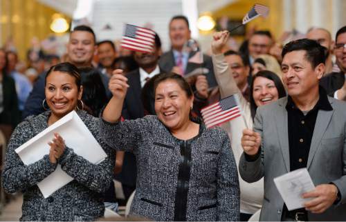Steve Griffin  |  The Salt Lake Tribune


Imelda Molina, center, who is originally from Mexico, smiles as she joins 142 people from 51 counties as they become new U.S. citizens during a naturalization ceremony at the State Capitol Rotunda in Salt Lake City, Monday, March 28, 2016.