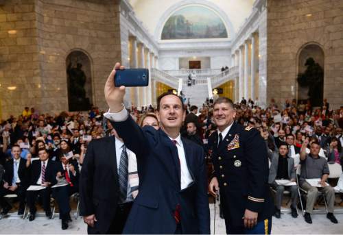 Steve Griffin  |  The Salt Lake Tribune


Rep. Norm Thurston, R-Provo takes a selfie with 142 new U.S. citizens from 51 counties as he conducts a naturalization ceremony at the State Capitol Rotunda in Salt Lake City, Monday, March 28, 2016.