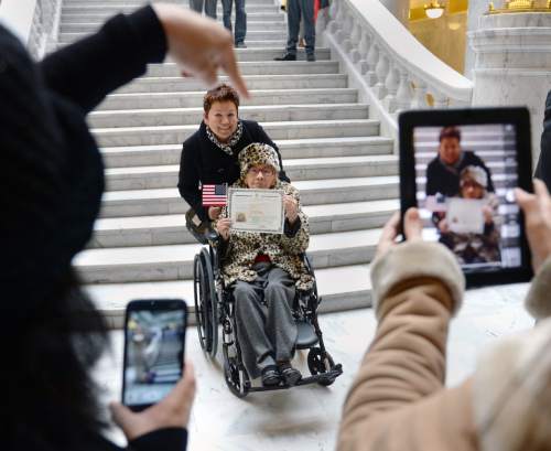 Steve Griffin  |  The Salt Lake Tribune


Elvira Giles holds up her Certificate of Naturalization as she is photographed with her daughter Jenney Spencer after she and 142 people from 51 counties were sworn in as new U.S. citizens during a naturalization ceremony at the State Capitol Rotunda in Salt Lake City, Monday, March 28, 2016. Giles has lived in the United States for the past 20 years is originally from Mexico.