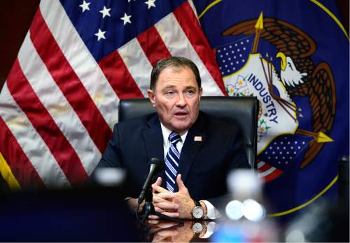 Scott Sommerdorf   |   Tribune file photo
Utah Gov. Gary Herbert made references to biblical and Mormon scripture as he signed a bill making "In God We Trust" license plates one of the standard opitions, with no extra charge for specialty plates.
