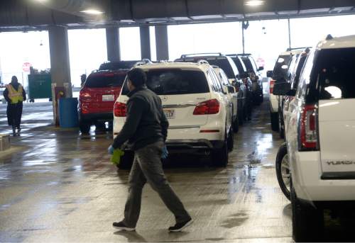 Al Hartmann  |  The Salt Lake Tribune 
Workers push returned rental cars at Salt Lake International Airport's newly opened quick turn around facility Monday March 28.  The airport just just completed the car rental maintainence facility a couple months ago.  It is an early part of the $1.8 billion terminal redevelop program.