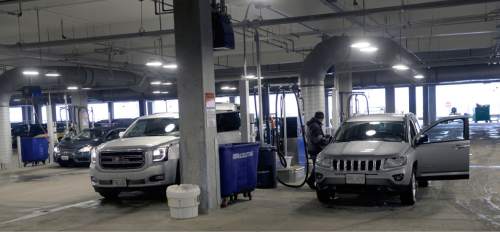 Al Hartmann  |  The Salt Lake Tribune 
Workers clean out and vacume returned rental cars at Salt Lake International Airport's newly opened quick turn around facility Monday March 28.  The airport just just completed the car rental maintainence facility a couple months ago.  It is an early part of the $1.8 billion terminal redevelop program.