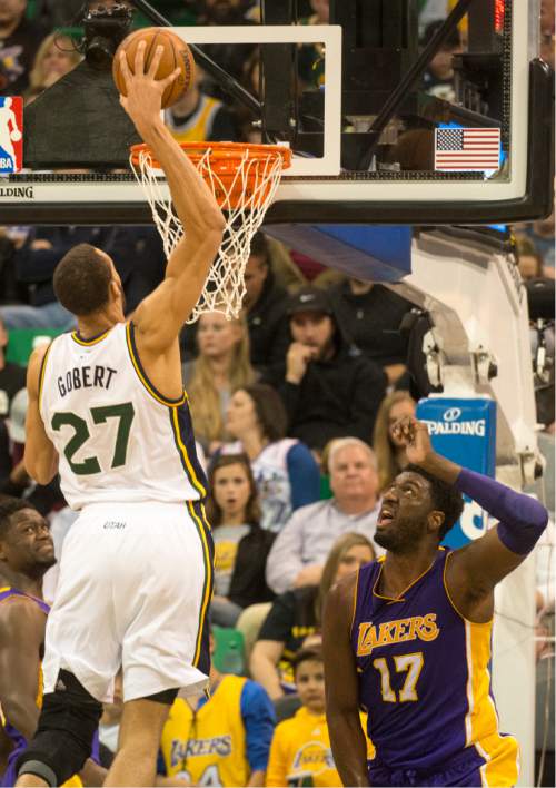 Rick Egan  |  The Salt Lake Tribune

Utah Jazz center Rudy Gobert (27) dunks het ball overLos Angeles Lakers center Roy Hibbert (17), as the Utah Jazz played The Los Angeles Lakers, in Salt Lake City, Monday, March 28, 2016.