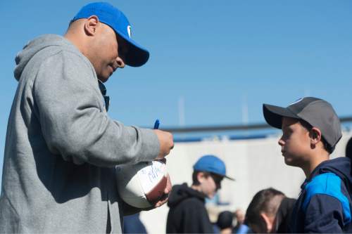 Rick Egan  |  The Salt Lake Tribune

Michael Sumko gets an autograph from BYU Head Coach Kalani Sitake, after the final practice of spring camp, at LaVell Edwards Stadium, Friday, April 1, 2016.