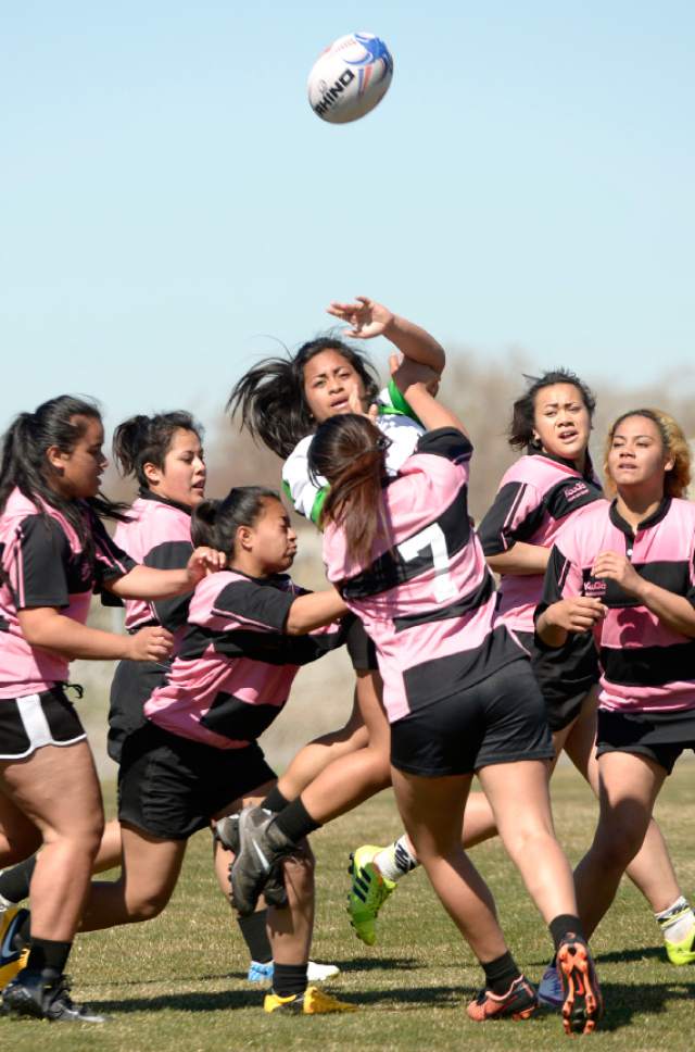 Leah Hogsten  |  The Salt Lake Tribune
Kau Toa Girls Rugby Club player throws a pass during their club game against Salt Lake Silverbacks. Thousands attended Salt Lake City's Regional Athletic Complex opening Saturday, April 2, 2016. Activities  included rugby, soccer, lacrosse, ultimate Frisbee and quidditch exhibition games, soccer and ultimate Frisbee clinics and Utah Bubble Balls sports activities.