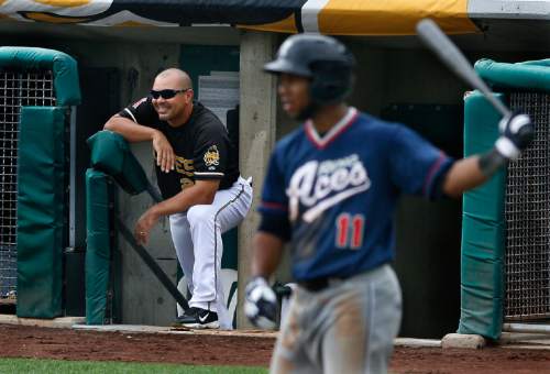 Scott Sommerdorf   |  The Salt Lake Tribune

Bees manager Keith Johnson chuckles at the response he got from one of his infielders after he gave him signs from the dugout during the Salt Lake Bees 10-7 loss to the Reno Aces, Sunday, September 1, 2013. The Aces' Alfredo Marte is coming to bat at right.