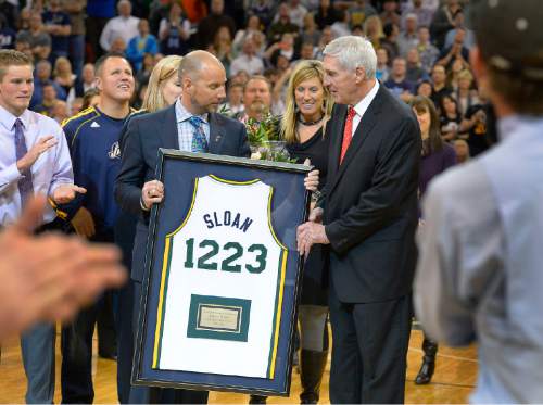 Scott Sommerdorf   |  The Salt Lake Tribune

Steve Miller hands Jerry Sloan a commemorative jersey with noting his total NBA victories as he was honored during halftime as the Jazz hosted the Golden State Warriors, Friday, Jan. 31, 2014.