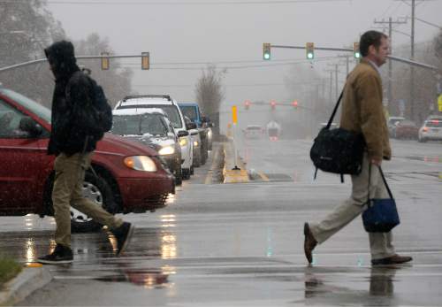 Al Hartmann  |  The Salt Lake Tribune 
Commuters saw a mixture of rain and snow in downtown Salt Lake City on Monday,  March 28, 2016, as a large storm system set in last week. While mountain snow accumulation looks good this season, forecasters say dry soils may soak up a significant portion of spring runoff.