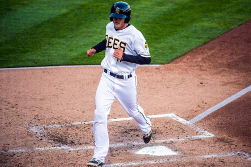 Chris Detrick  |  The Salt Lake Tribune
Salt Lake Bees left fielder Nick Buss (17) scores a run during the game at Smith's Ballpark Thursday April 7, 2016.