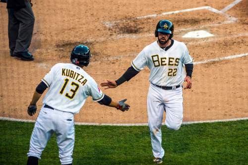 Chris Detrick  |  The Salt Lake Tribune
Salt Lake Bees third baseman Kaleb Cowart (22) celebrates with Salt Lake Bees third baseman Kyle Kubitza (13) after he scored a run during the game at Smith's Ballpark Thursday April 7, 2016.