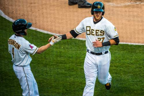 Chris Detrick  |  The Salt Lake Tribune
Salt Lake Bees catcher Jett Bandy (27) celebrates with Salt Lake Bees left fielder Shane Robinson (4) after he scored a run during the game at Smith's Ballpark Thursday April 7, 2016.