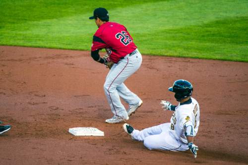 Chris Detrick  |  The Salt Lake Tribune
Salt Lake Bees second baseman Gregorio Petit (8) slides safely into second base past Sacramento River Cats second baseman Ramiro Pena (26) during the game at Smith's Ballpark Thursday April 7, 2016.