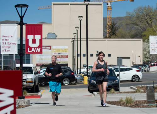 Lennie Mahler  |  The Salt Lake Tribune

University of Utah law students Scott Manning and Brooke Parrish cross the finish line of a mile route around campus Thursday, April 7, 2016. Law students and faculty worked to accumulate a total of 100 miles before law school dean Robert Adler runs a 100-mile course in Zion National Park on Friday. Adler will run the ultra-marathon to push for a 100% bar exam passage rate and 100% employment for law graduates.