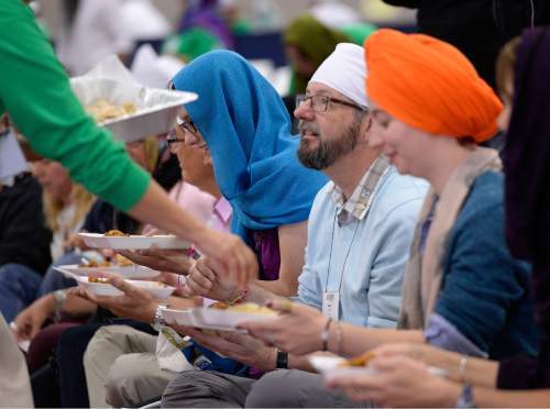 Al Hartmann  |  The Salt Lake Tribune
Several thousand attending the Parliament of the World's Religions wearing head covering sit together as equals on the floor of the Salt Palace Convention Center Friday, Oct. 16 and served food by members of the Sikh religious community at a traditional Langar.  Langar is a 500-year-old Sikh religion tradition where vegetarian food is served to all for free, regardless of religion or class.  Langar expresses the ideals of community, sharing and oneness of mankind.