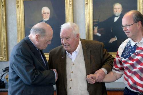 Al Hartmann  |  The Salt Lake Tribune 
Charles Howard, an Army POW who served in Korea, left, shakes hands with Robert L. Monson who was an Army Air Corp and POW in World War II, Friday April 8 at Utahís annual POW luncheon at the Zions Bank Building in Salt Lake City. Monson's son Jan, right. Former prisoners of war that fought in World War II, Korea and Vietnam were honored.  The luncheon is organized by the U.S. Department of Veterans Affairs.