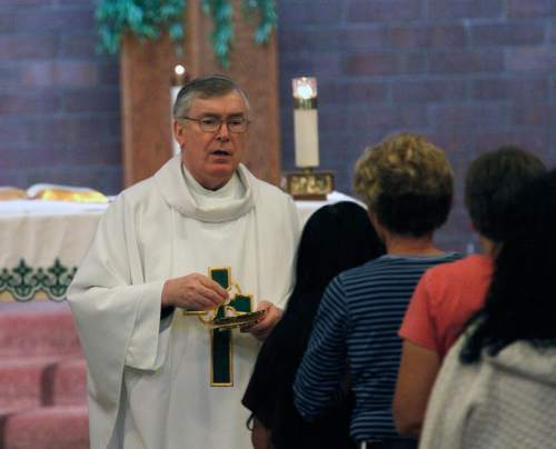 Al Hartmann  |  The Salt Lake Tribune

Monsignor Francis Mannion conducts Mass at St. Vincent de Paul Catholic Church in 2012.