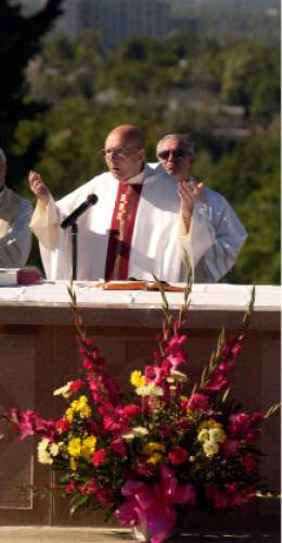 Rick Egan  |  The Salt Lake Tribune

Mosignor J. Terrence Fitzgerald celebrates Mass at the Mount Calvary Catholic Cemetery in Salt Lake City in 2014.