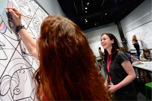 Scott Sommerdorf   |  The Salt Lake Tribune  
Marissa Di Simone, right, the Leonardo's exhibit developer speaks with Shanna Futral, left, as she colors on one of the exhibits. The Leonardo hosted a Weekend of Welcome, designed to support refugees and the organizations that help them make a successful transition into a new life, Saturday, April 9, 2016.