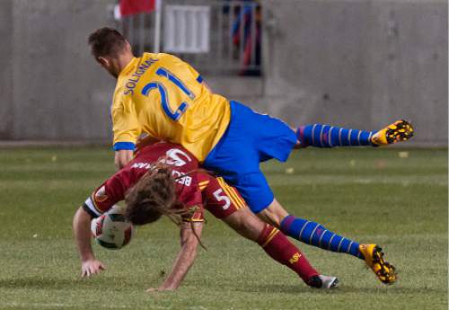 Michael Mangum  |  Special to the Tribune

Colorado Rapids forward Luis Solignac (21) falls on top of Real Salt Lake midfielder Kyle Beckerman (5) during the second half their match at Rio Tinto Stadium in Sandy, UT on Saturday, April 9, 2016. RSL won 1-0.