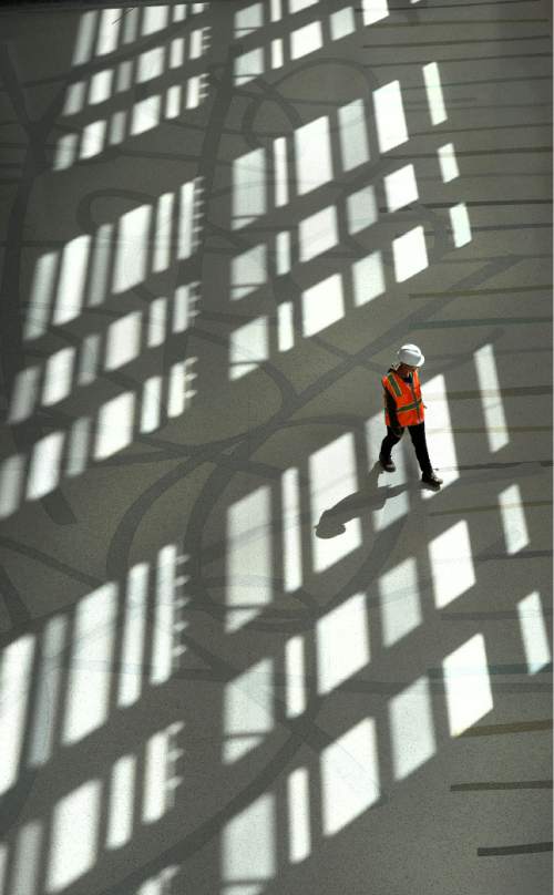 Steve Griffin  |  The Salt Lake Tribune


Artist Laura Sharp Wilson walks across the modern terrazzo floor she design for the Grand Lobby of the new  Eccles Theater in Salt Lake City, Monday, April 11, 2016.  Salt Lake City commissioned two public art projects for the theater and one of them is a modern terrazzo floor.  
Laura Sharp Wilson, a contractor who specializes in terrazzo, has been installing the floor over the last 2 weeks was seeing her finished work for the first time.  The floor installation was titled "Thread, Trail, Rope and Yarn, was inspired by the landscape of Utah and the history of the Salt Lake Valley.