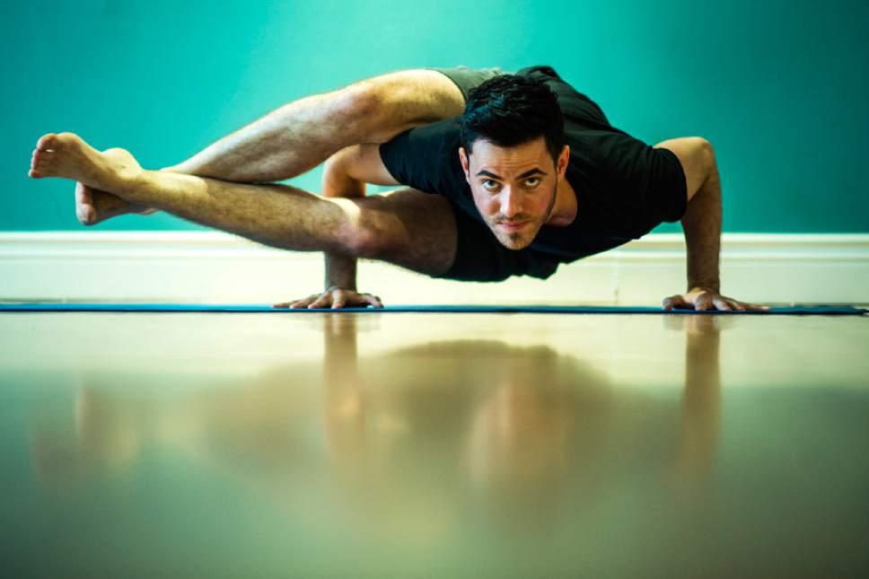 Chris Detrick  |  The Salt Lake Tribune
A.J. Walker does eight angle pose at Vitalize Studio in Sugar House Saturday March 19, 2016.