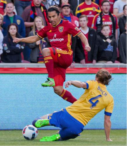 Michael Mangum  |  Special to the Tribune

Real Salt Lake defender Tony Beltran (2) leaps over a sliding Colorado Rapids defender Marc Burch (4) during their match at Rio Tinto Stadium in Sandy, UT on Saturday, April 9, 2016. RSL won 1-0.